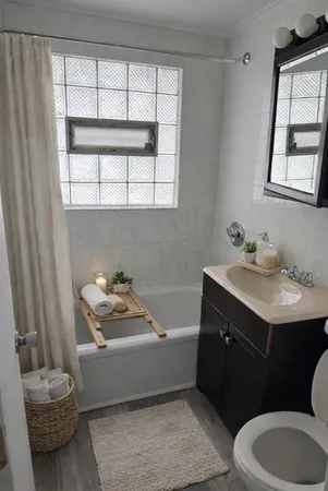 a bathroom with a sink toilet and tub
