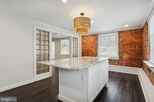 a kitchen with stainless steel appliances granite countertop a sink and wooden floor