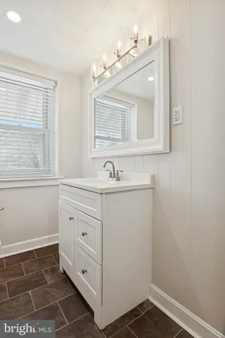 a bathroom with a sink a mirror and a vanity