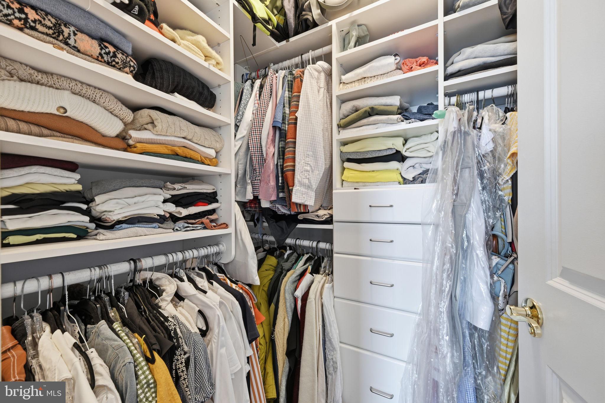 1229 12th Street Northwest, Unit 208 Washington, DC 20005 - Photo 25 of 35 a view of walk in closet with clothes and shoes