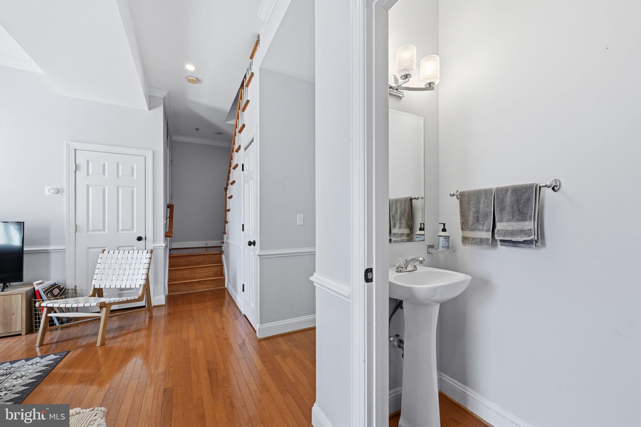 1229 12th Street Northwest, Unit 208 Washington, DC 20005 - Photo 26 of 35 a view of a hallway with wooden floor and staircase