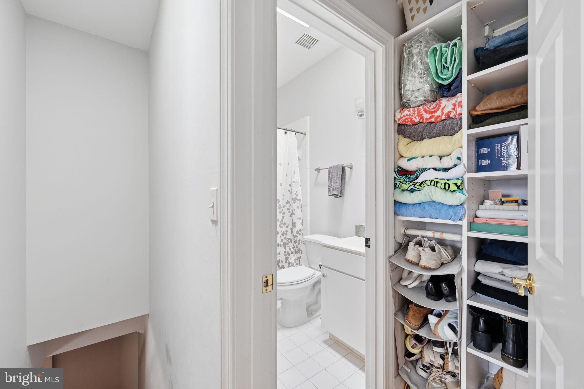 1229 12th Street Northwest, Unit 208 Washington, DC 20005 - Photo 29 of 35 a view of walk in closet with clothes and shoes