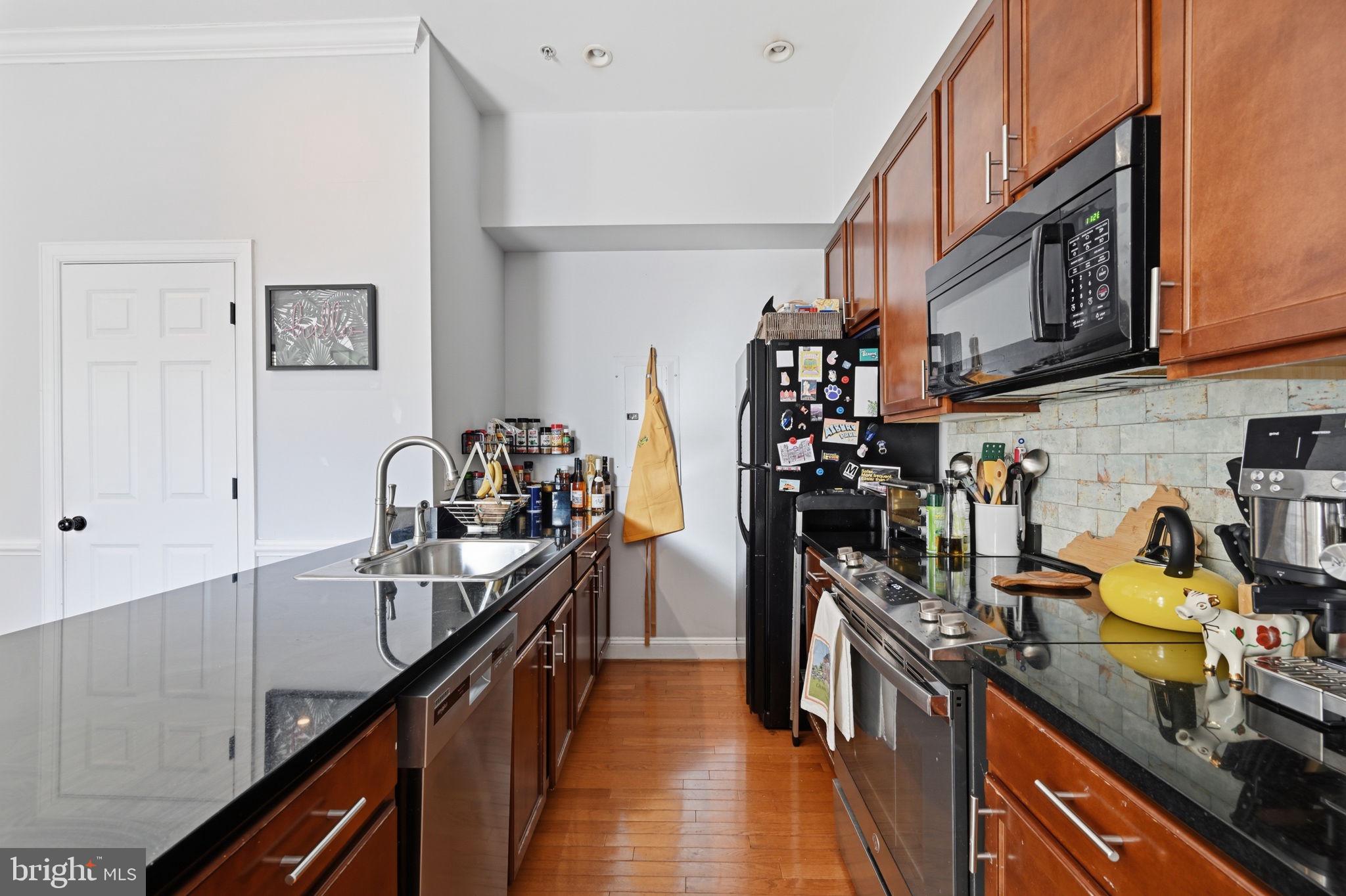 1229 12th Street Northwest, Unit 208 Washington, DC 20005 - Photo 4 of 35 a kitchen with lots of counter top space and stainless steel appliances