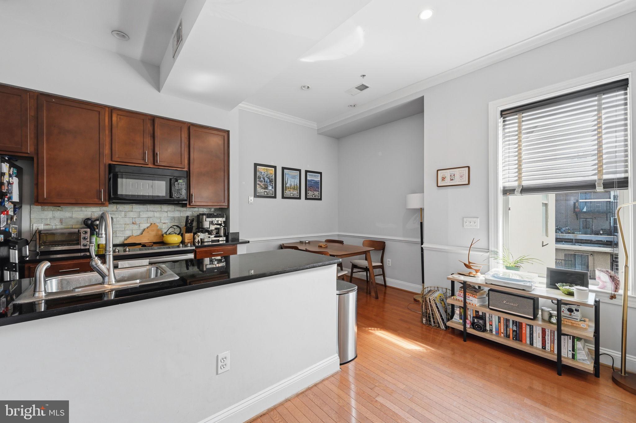 1229 12th Street Northwest, Unit 208 Washington, DC 20005 - Photo 6 of 35 a kitchen with stainless steel appliances a stove a sink a refrigerator and cabinets
