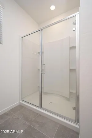 a bathroom with a glass shower door