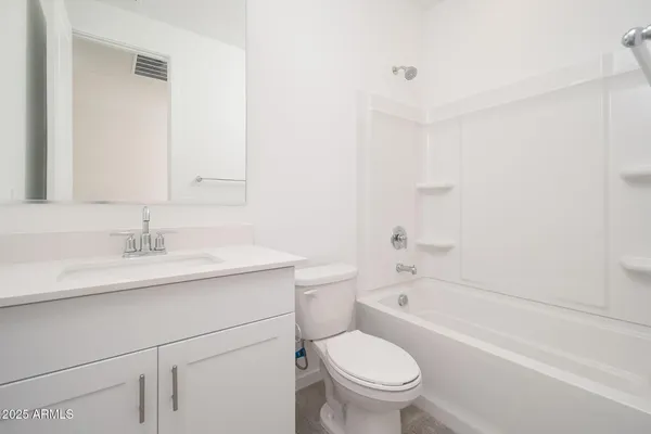 a bathroom with a sink toilet vanity and shower