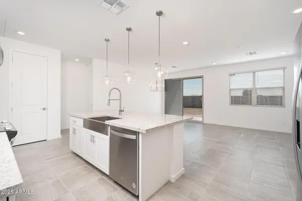 a kitchen with a sink stove and cabinets