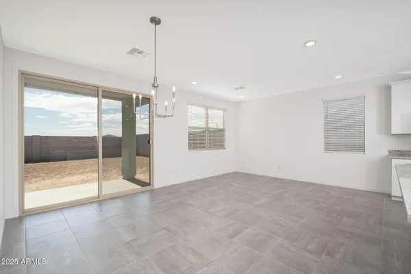 a view of an empty room with glass door