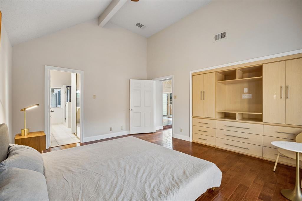 4115 Rive Lane Addison, TX 75001 - Photo 12 of 25 Vaulted ceiling with exposed beam and wood-finish flooring