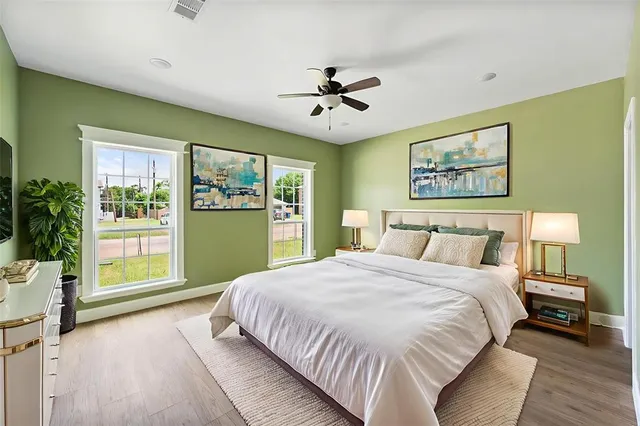 a spacious bedroom with a large bed and a large window