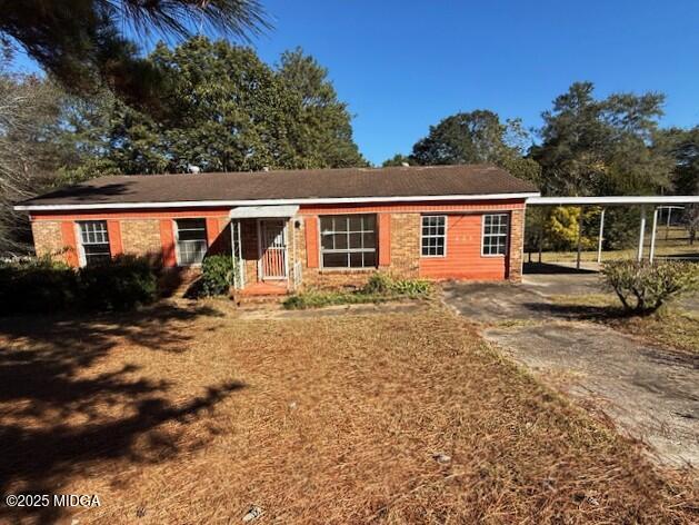 a view of house with backyard and trees in the background