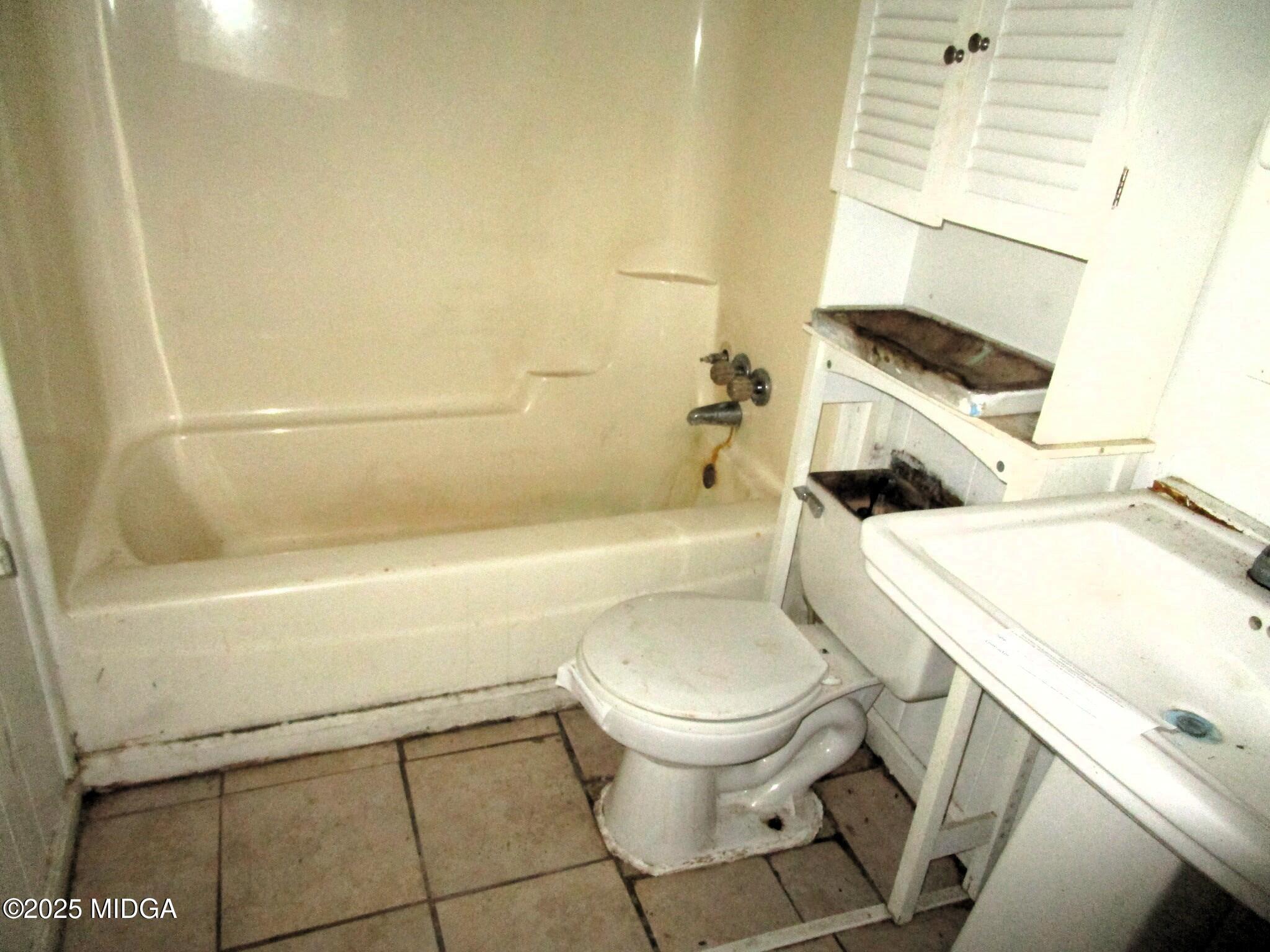 427 Gun Club Road Fort Valley, GA 31030 - Photo 7 of 12 a white toilet sitting next to a bath tub