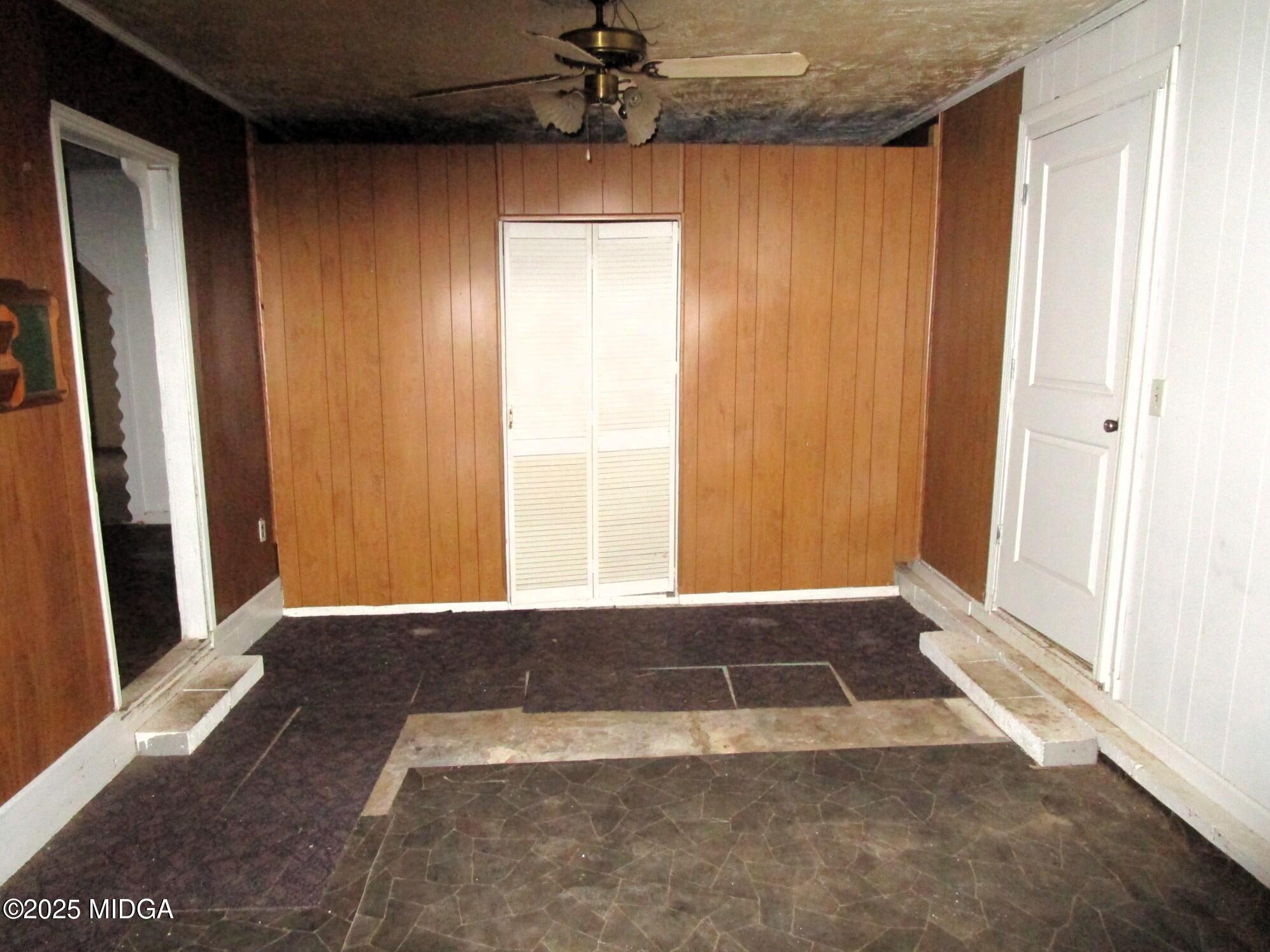427 Gun Club Road Fort Valley, GA 31030 - Photo 8 of 12 an empty room with windows and a ceiling fan