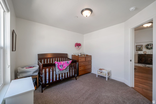1288 North Horizon View Loop Elk Ridge, UT 84651 - Photo 24 of 40 Bedroom with a nursery area and dark carpet