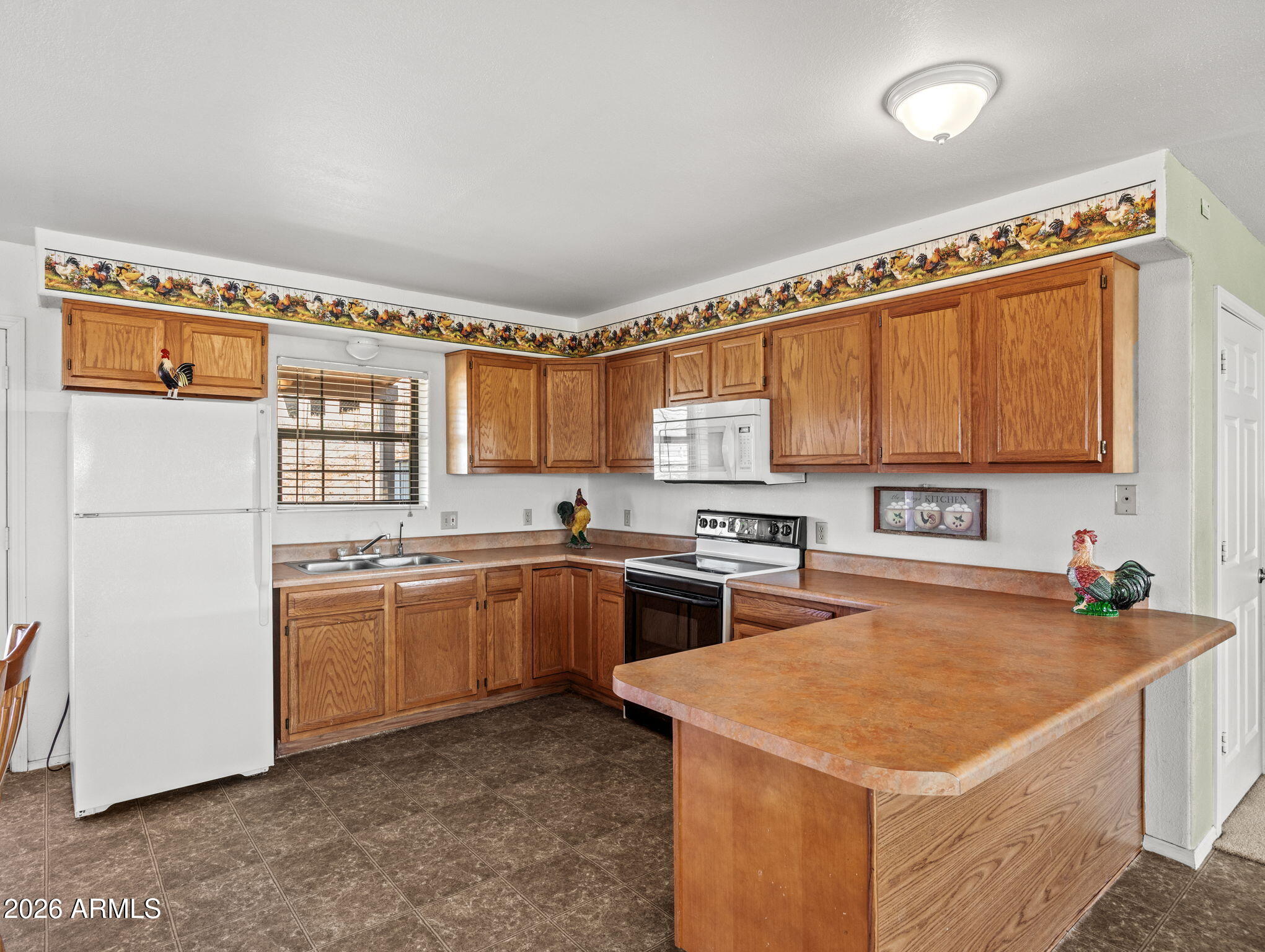 18420 Peeples Valley Road Peeples Valley, AZ 86332 - Photo 13 of 31 a kitchen with stainless steel appliances granite countertop a sink stove and refrigerator
