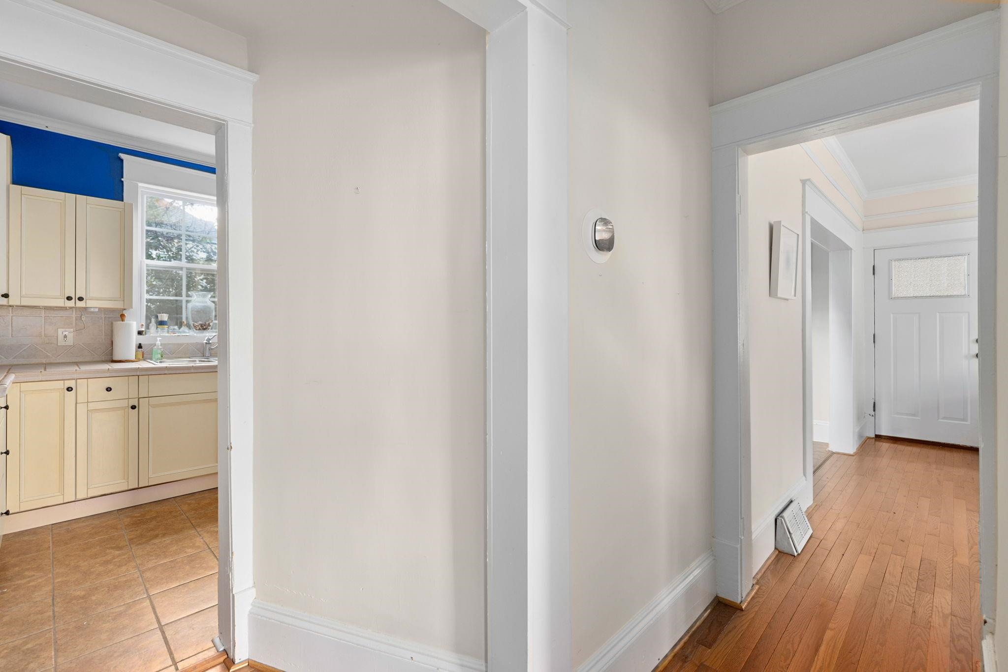 330 Pershing Road Raleigh, NC 27608 - Photo 10 of 51 The hallway offers hardwood flooring and leads past the living room and dining room and leads to the first of 2 full baths on the main floor. 1st Floor Hallway