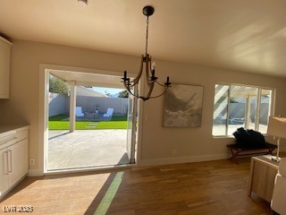 2712 Rialto Road Las Vegas, NV 89108 - Photo 27 of 54 Unfurnished dining area with a chandelier and dark wood-style flooring