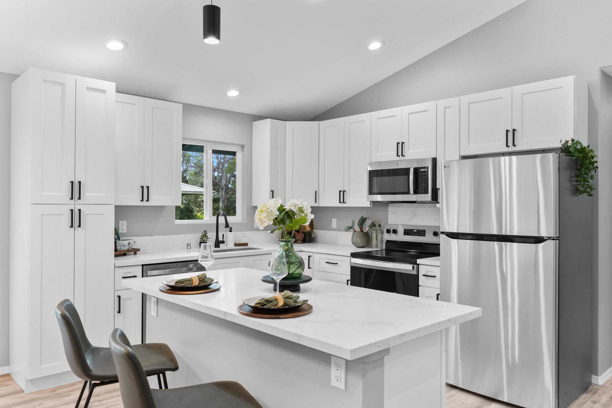 11-3343 Volcano Road Volcano, HI 96785 - Photo 12 of 30 a kitchen with white cabinets and stainless steel appliances