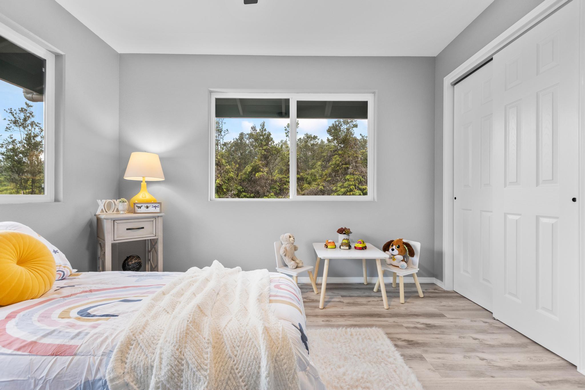 11-3343 Volcano Road Volcano, HI 96785 - Photo 27 of 30 a bedroom with a bed a table and a window