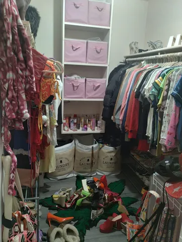 a store room with lots of different colored cloths