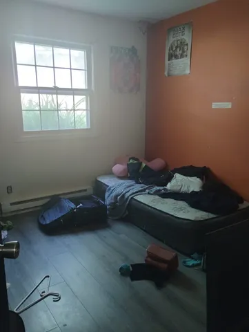 a bedroom with a bed and a window