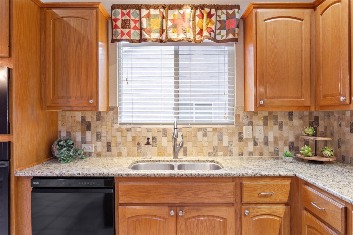246 Red Poppy Trail Georgetown, TX 78633 - Photo 16 of 32 a kitchen with stainless steel appliances granite countertop a sink and a window