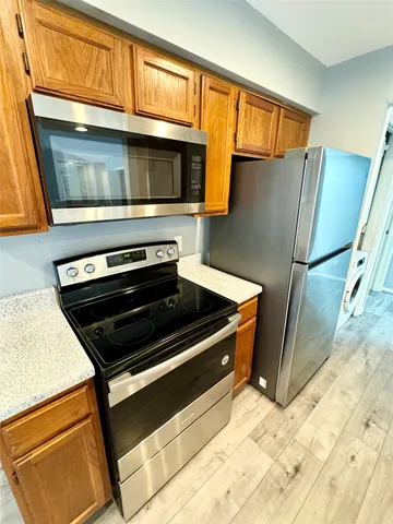 a kitchen with stainless steel appliances a stove and a microwave