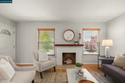 a living room with furniture a window and a fireplace