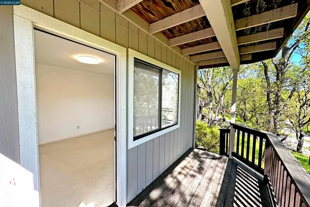 a view of a porch with wooden floor and outdoor space