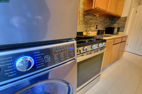 a kitchen with stainless steel appliances granite countertop a stove and a microwave