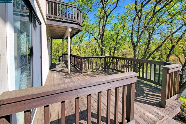 a view of balcony with wooden floor and outdoor seating