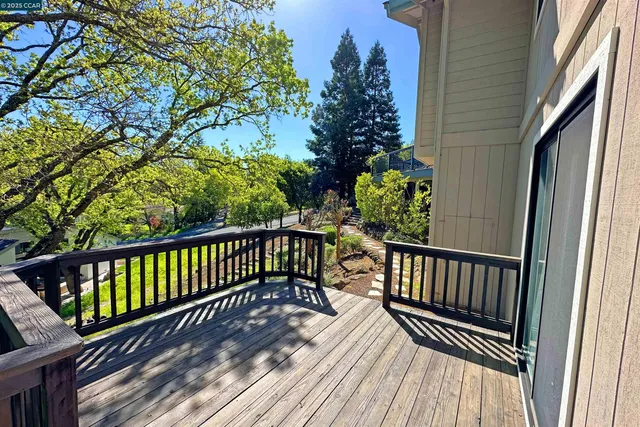 a view of balcony with wooden floor and outdoor seating