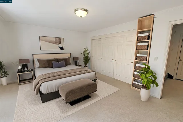 a bedroom with a bed and a potted plant