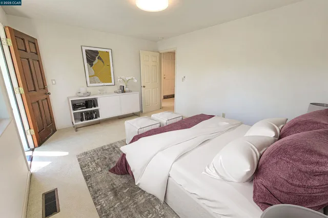 a bedroom with a bed and dresser