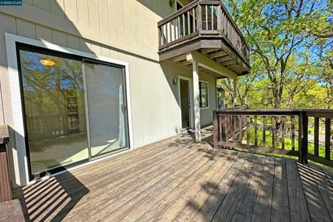 a view of balcony with wooden floor