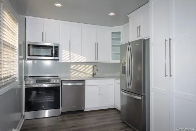 a kitchen with stainless steel appliances and wooden cabinets
