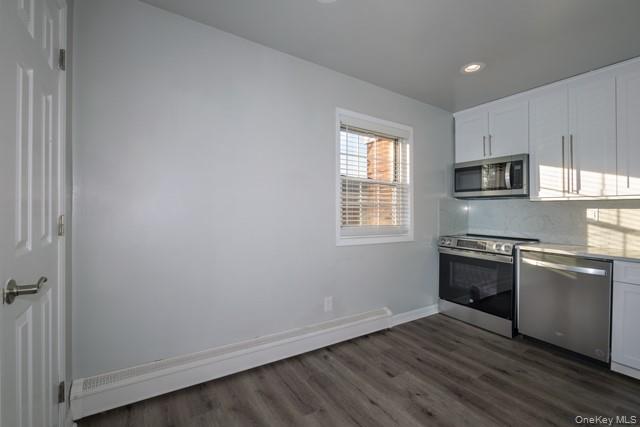 140 Sussex Place, Unit SH07 Bohemia, NY 11716 - Photo 3 of 11 a kitchen with granite countertop cabinets stainless steel appliances and a window
