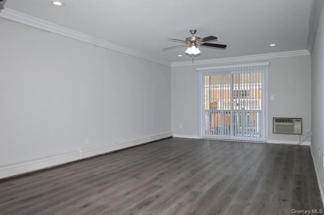 140 Sussex Place, Unit SH07 Bohemia, NY 11716 - Photo 4 of 11 a view of an empty room with wooden floor and a window