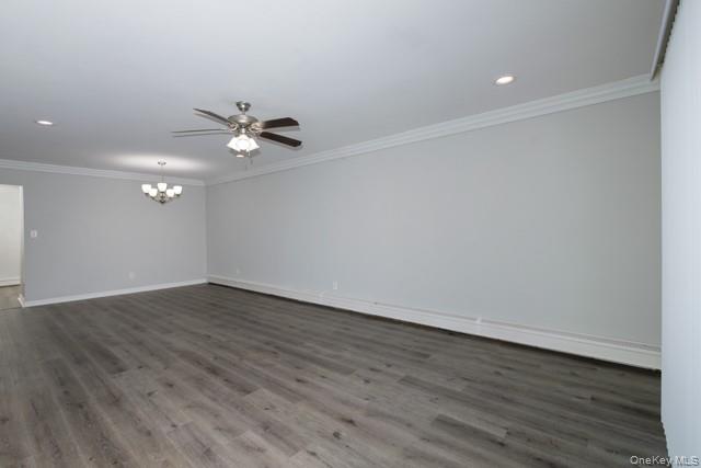 140 Sussex Place, Unit SH07 Bohemia, NY 11716 - Photo 5 of 11 a view of an empty room with wooden floor and a ceiling fan