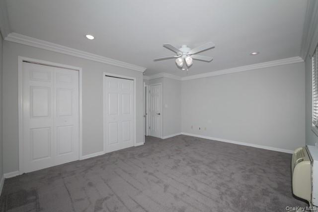 140 Sussex Place, Unit SH07 Bohemia, NY 11716 - Photo 9 of 11 an empty room with a ceiling fan and a window