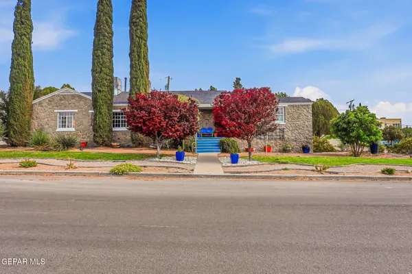 a multi story building with trees in front of it