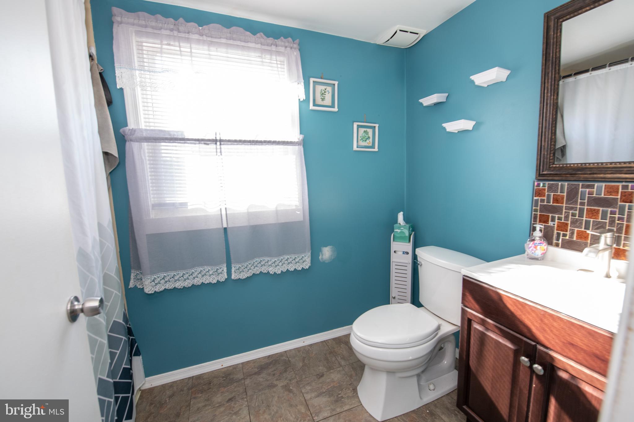 618 Cedar Avenue Croydon, PA 19021 - Photo 11 of 14 a bathroom with a toilet a sink and a mirror