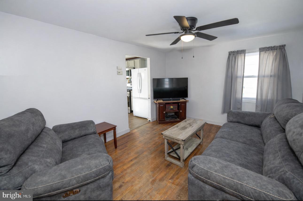 618 Cedar Avenue Croydon, PA 19021 - Photo 2 of 14 a living room with furniture and a flat screen tv with wooden floor