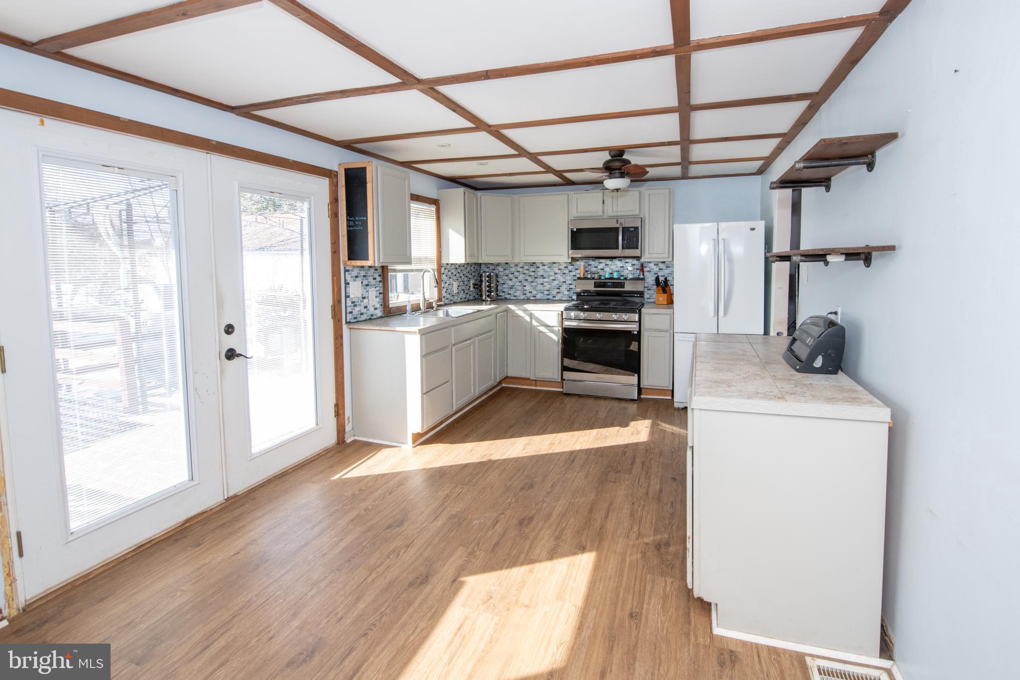 618 Cedar Avenue Croydon, PA 19021 - Photo 4 of 14 a view of a kitchen with furniture and wooden floor