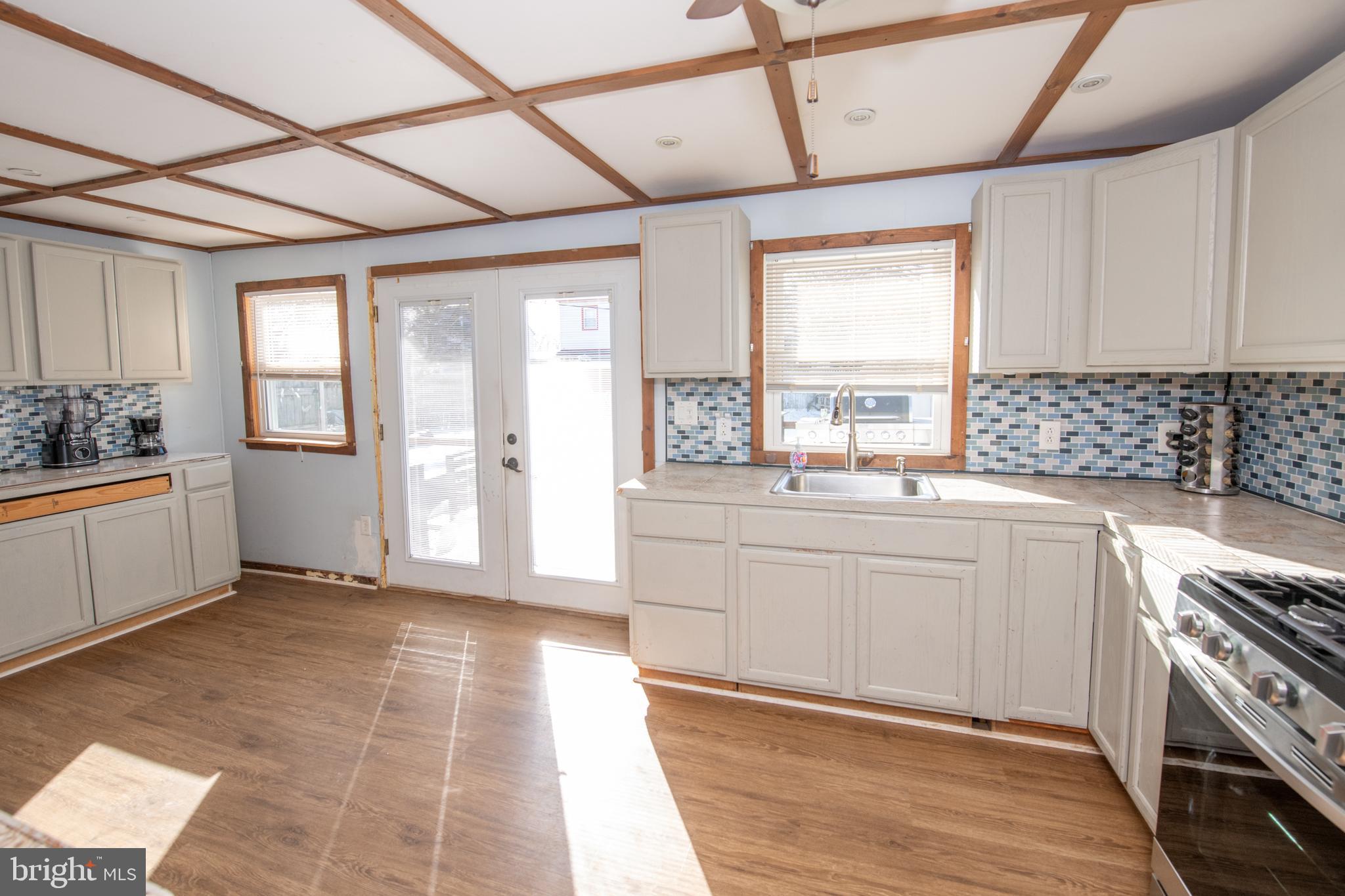 618 Cedar Avenue Croydon, PA 19021 - Photo 5 of 14 a kitchen with granite countertop a stove a sink and a refrigerator