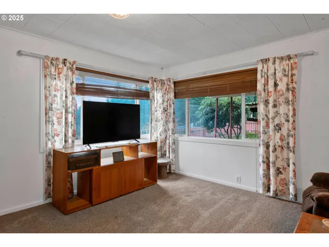 a living room with furniture a rug and a bookshelf