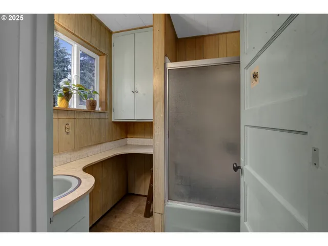 a view of room with a ceiling fan and a window
