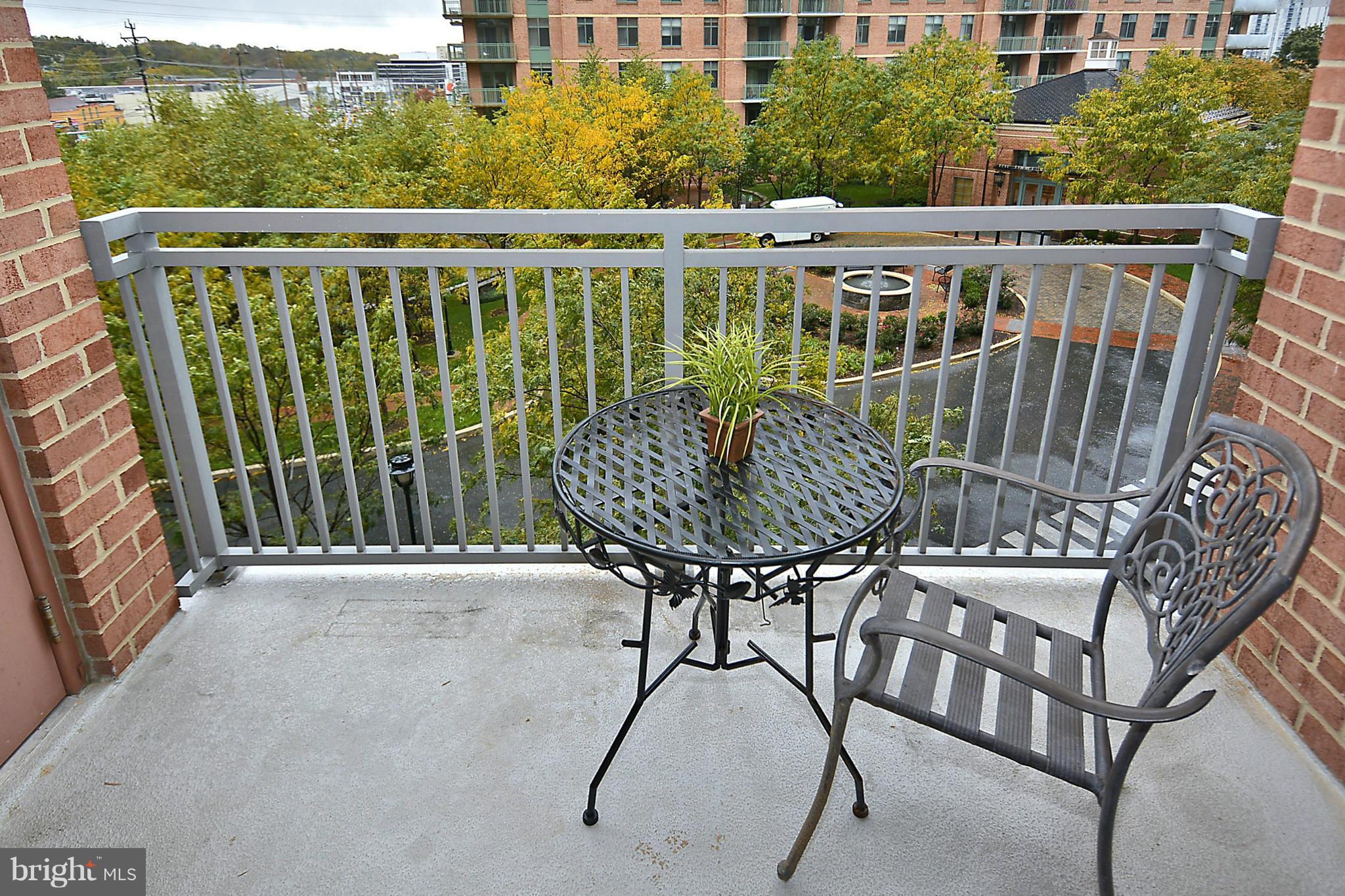 11710 Old Georgetown Road, Unit 419 North Bethesda, MD 20852 - Photo 17 of 30 a view of balcony with wooden floor and outdoor seating