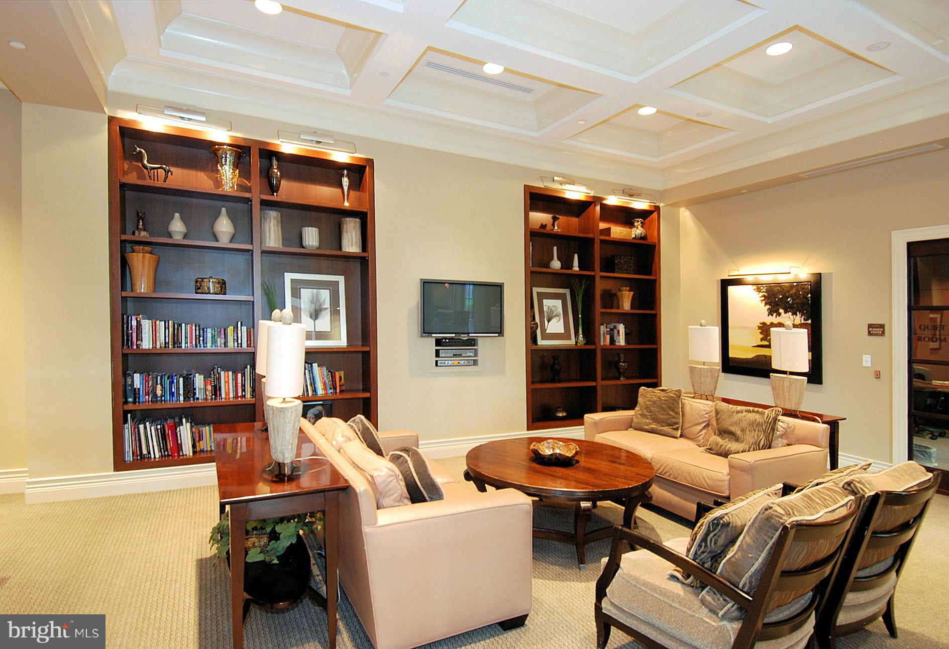 11710 Old Georgetown Road, Unit 419 North Bethesda, MD 20852 - Photo 20 of 30 a living room with furniture a rug and a book shelf
