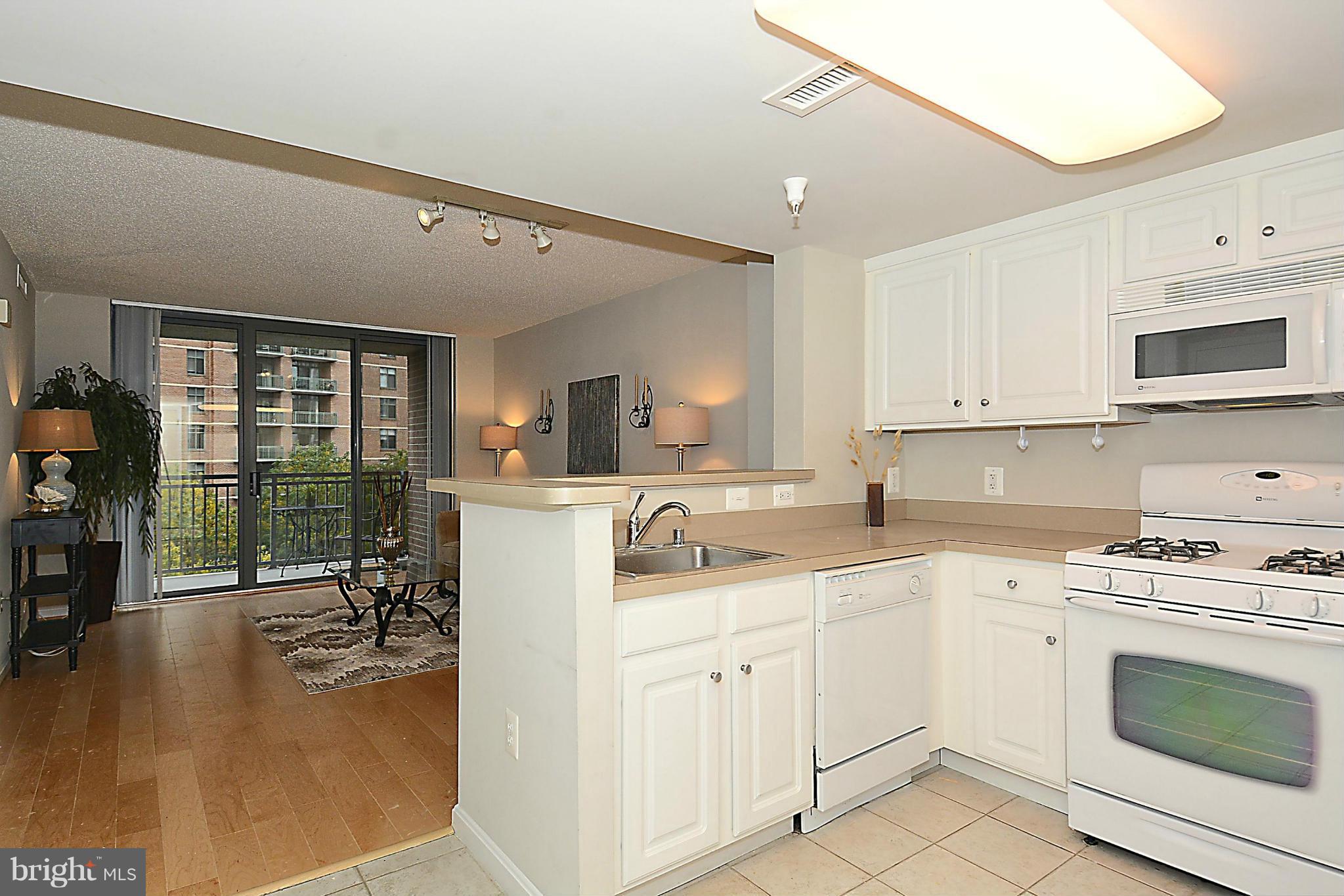 11710 Old Georgetown Road, Unit 419 North Bethesda, MD 20852 - Photo 6 of 30 a kitchen with a sink stove and cabinets